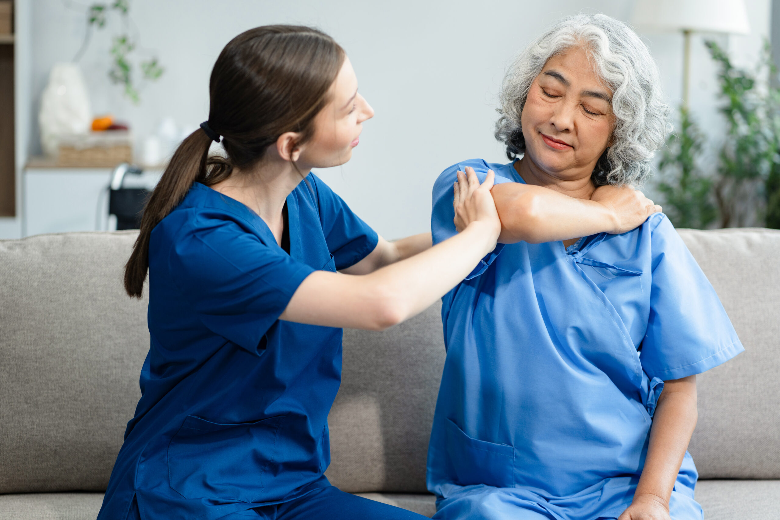 A caregiver comforting an older woman